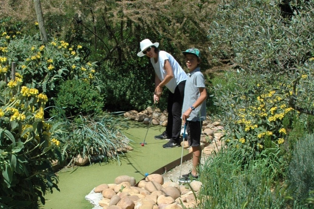 Photo of a family playing mini golf